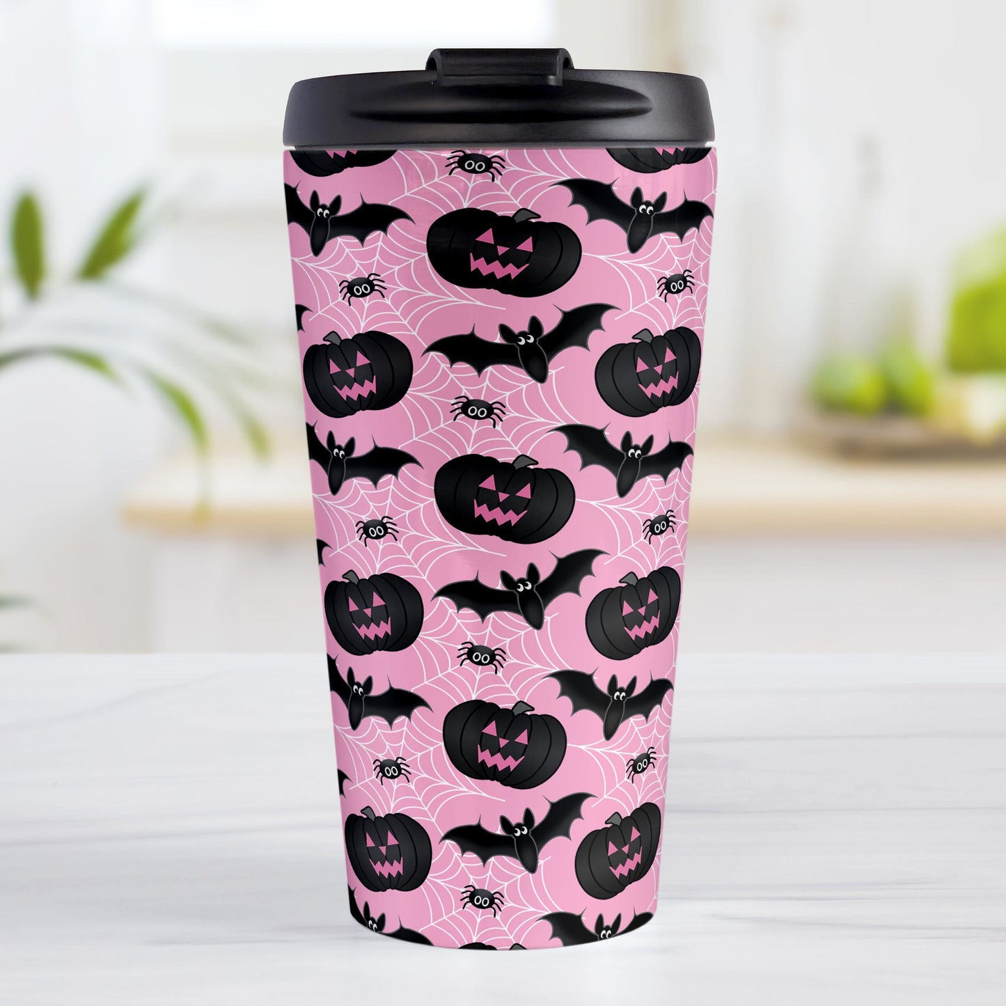 Black Pumpkins Bats and Spiders Pink Halloween Travel Mug (15oz) at Amy's Coffee Mugs. A travel mug designed with a pattern of black carved pumpkins, bats, and spiders in their webs in a pattern over a pink background color that wraps around the mug.