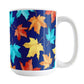 15 oz Blue Fall Leaves Mug with colorful turquoise, orange, and yellow autumn leaves over a deep navy blue background.