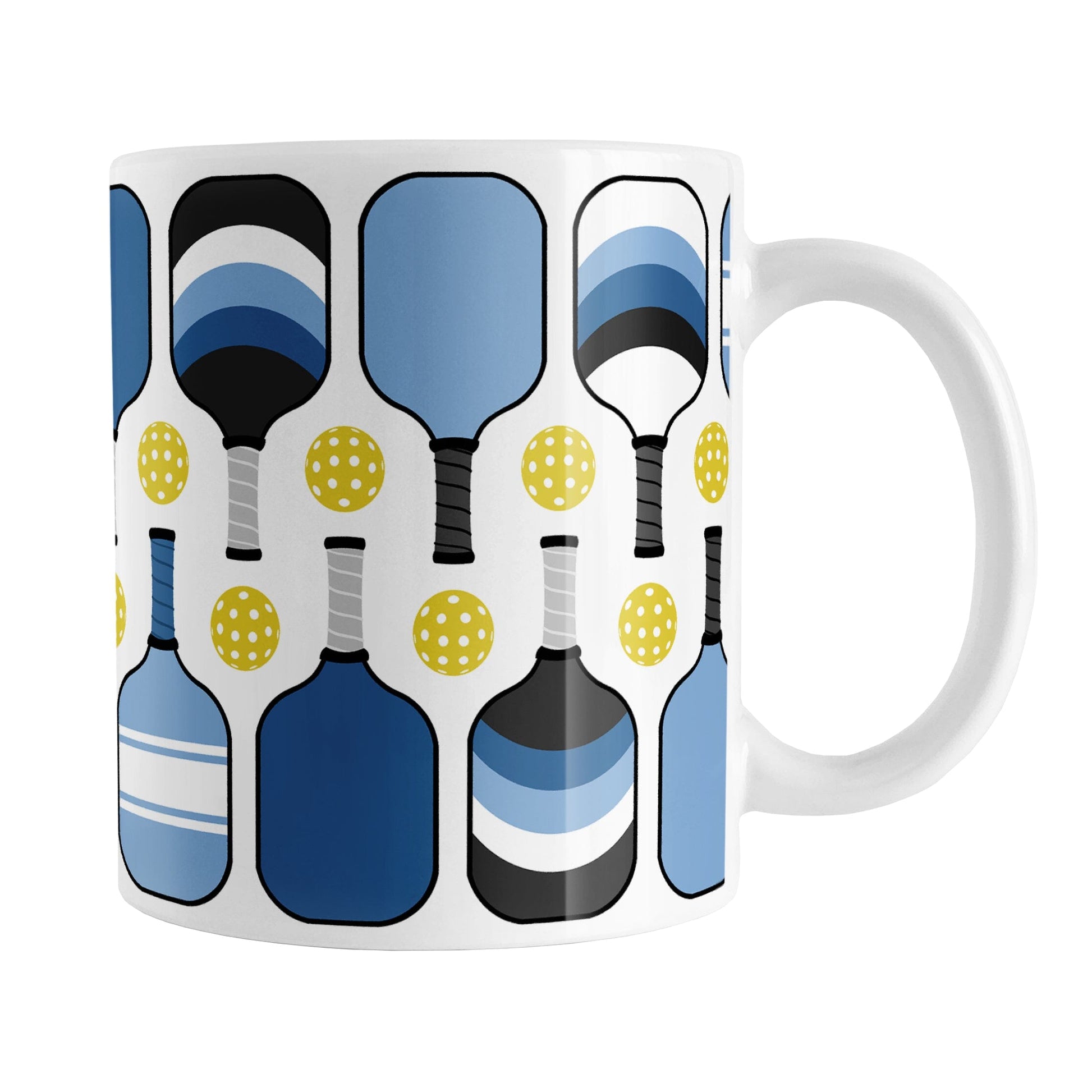 Blue Pickleball Mug (11oz) at Amy's Coffee Mugs. A ceramic coffee mug designed with modern blue pickleball paddles and yellow balls in a pattern that wraps around the mug up to the handle.
