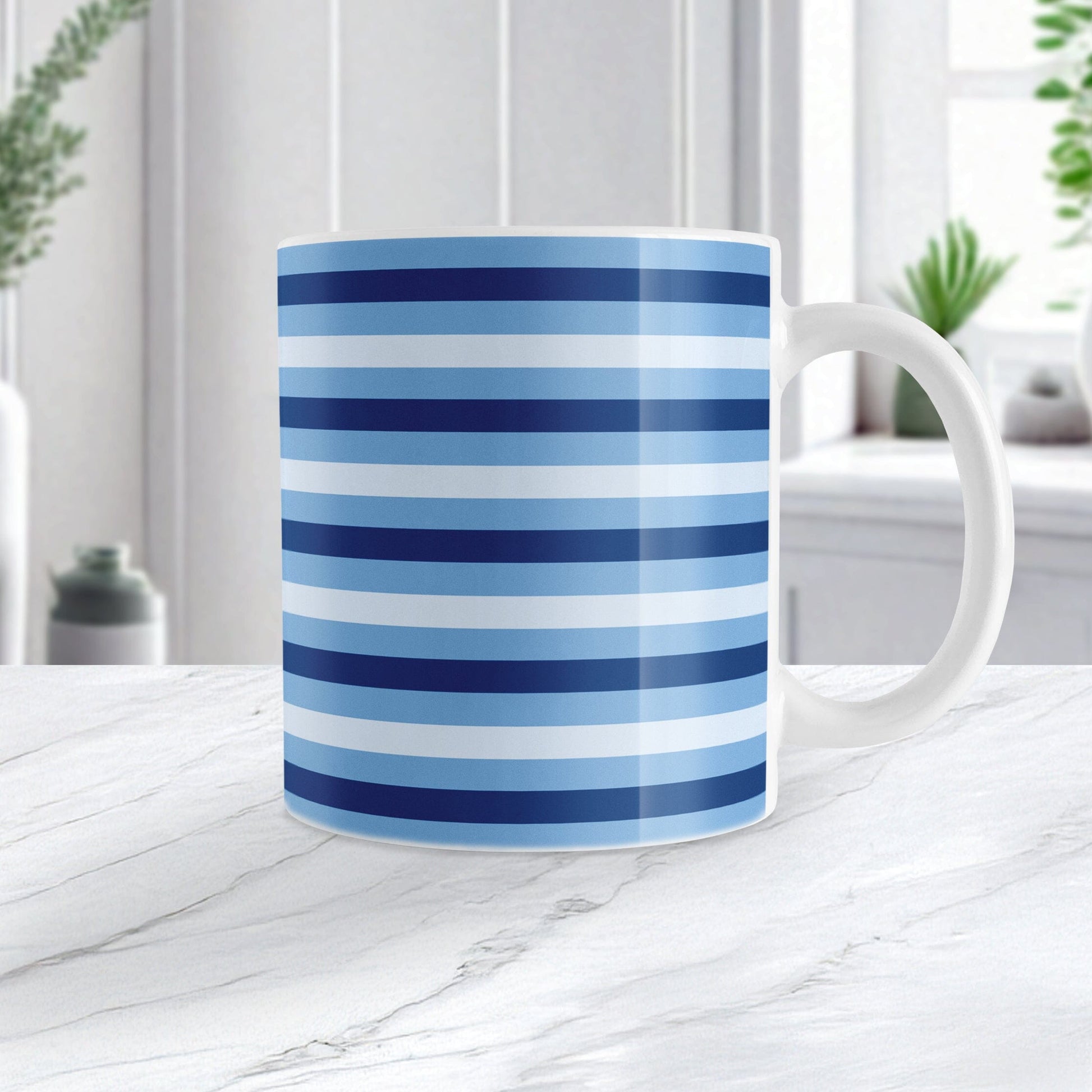 Mug with blue stripes on a marble surface with plants in the background