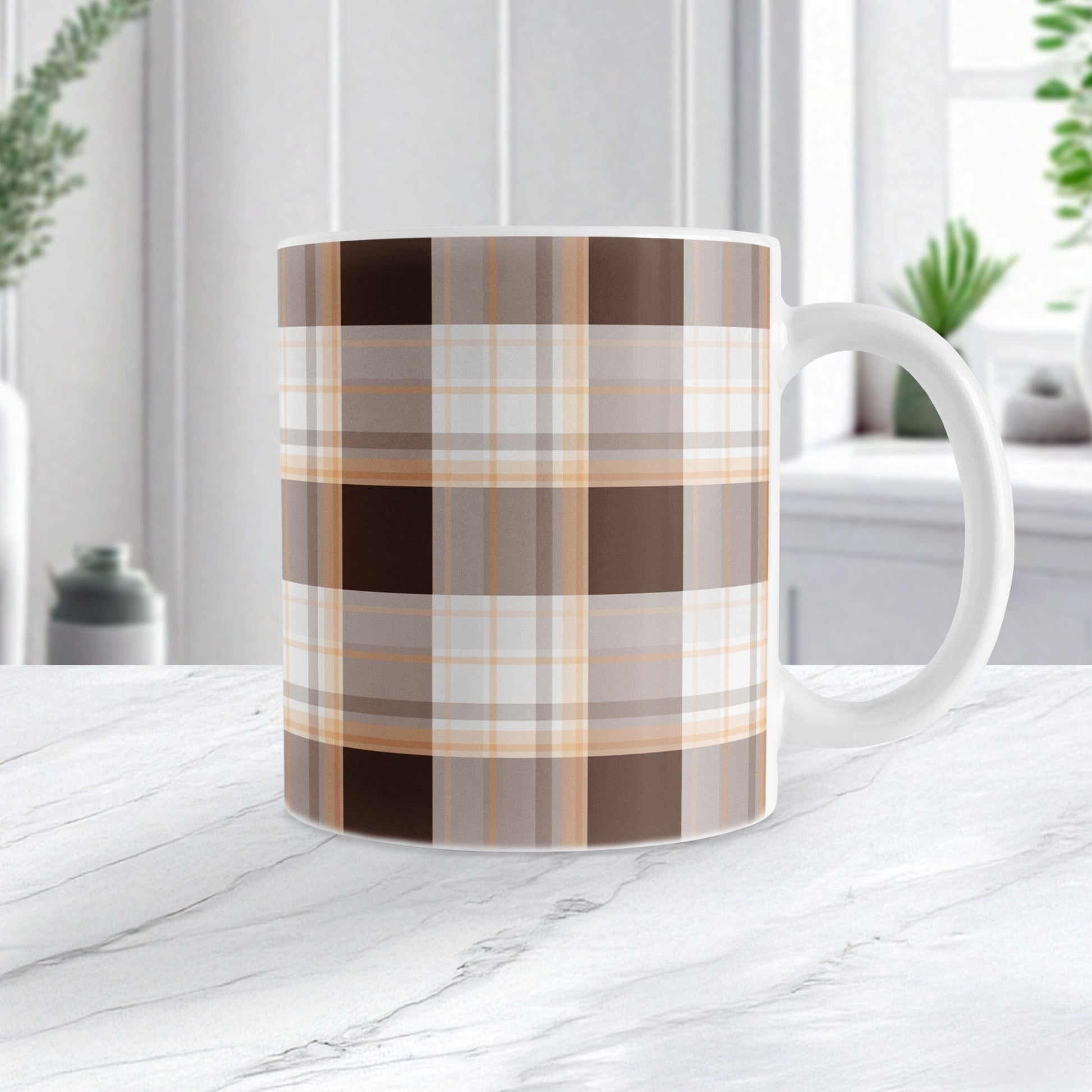 11 oz brown orange plaid mug with dark brown, light brown, white, and warm orange layered plaid pattern, on a marble countertop in a white kitchen.