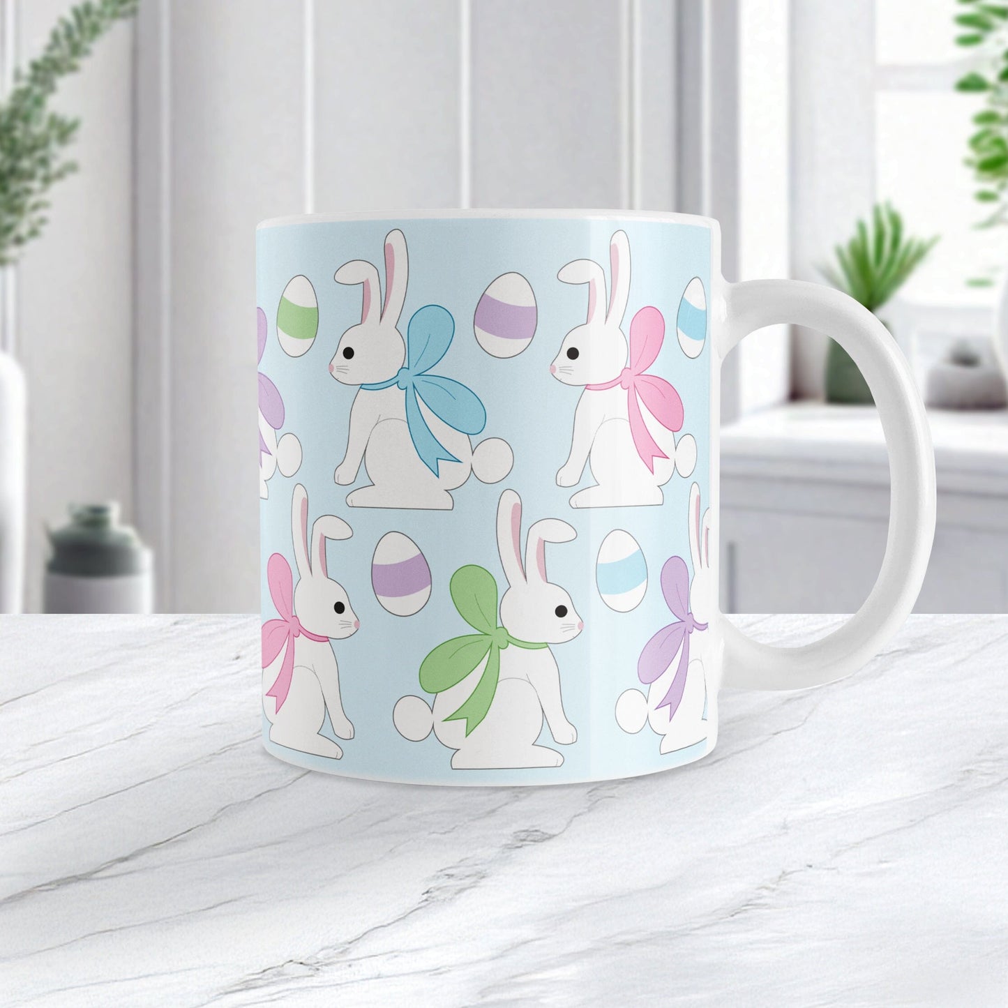 11oz mug with Easter-themed design featuring bunnies and eggs on a light blue background, on a marble countertop