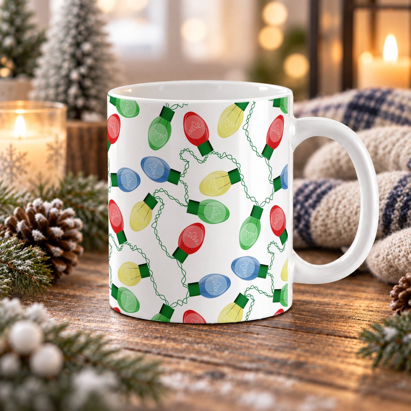 11 oz Christmas lights mug with red, blue, green, and yellow bulbs connected by looping green cords across white ceramic, displayed on a wooden table with winter decor around it.