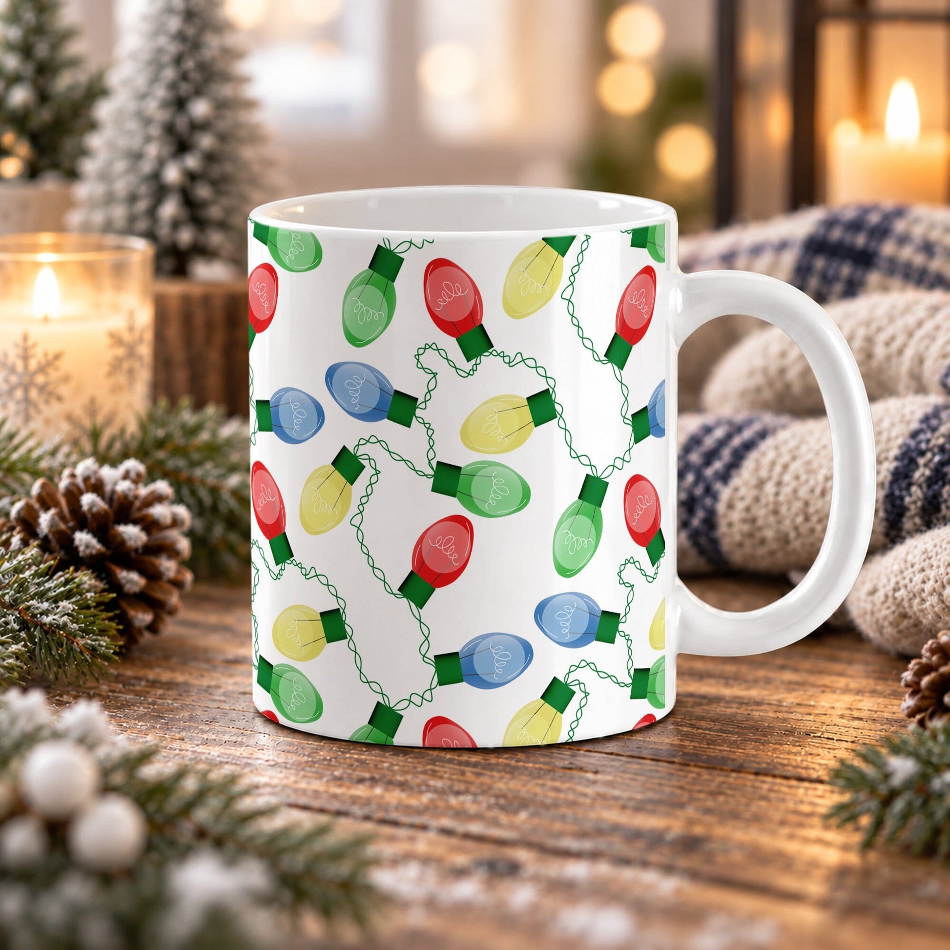 11 oz Christmas lights mug with red, blue, green, and yellow bulbs connected by looping green cords across white ceramic, displayed on a wooden table with winter decor around it.