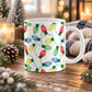 11 oz Christmas lights mug with red, blue, green, and yellow bulbs connected by looping green cords across white ceramic, displayed on a wooden table with winter decor around it.