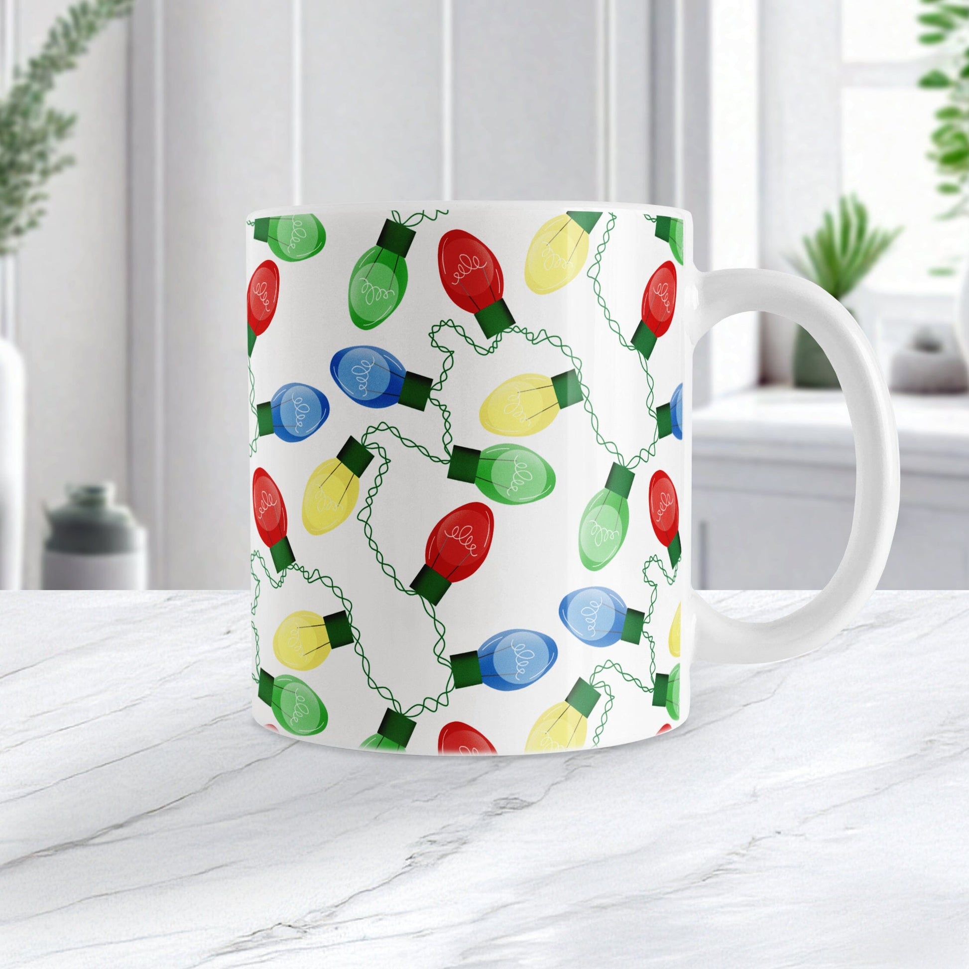 Mug with colorful Christmas light bulb pattern on a white surface.
