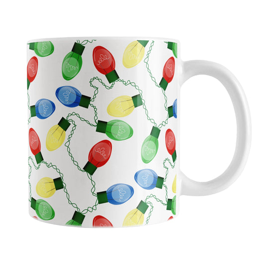 White mug with colorful Christmas light bulb pattern on a white background