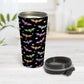 Colorful Bats Travel Mug at Amy's Coffee Mugs. A 15oz travel mug designed with different colored bats and white stars in an assorted pattern over a black background color that wraps around the mug. Photo shows the mug open on a table with its lid beside it.