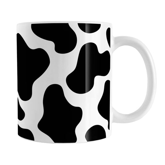 Cow Print Mug (11oz) at Amy's Coffee Mugs. A ceramic coffee mug designed with a black and white animal print pattern inspired by the spots on a cow that wraps around the mug.
