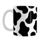 Cow Print Mug (11oz) at Amy's Coffee Mugs. A ceramic coffee mug designed with a black and white animal print pattern inspired by the spots on a cow that wraps around the mug.