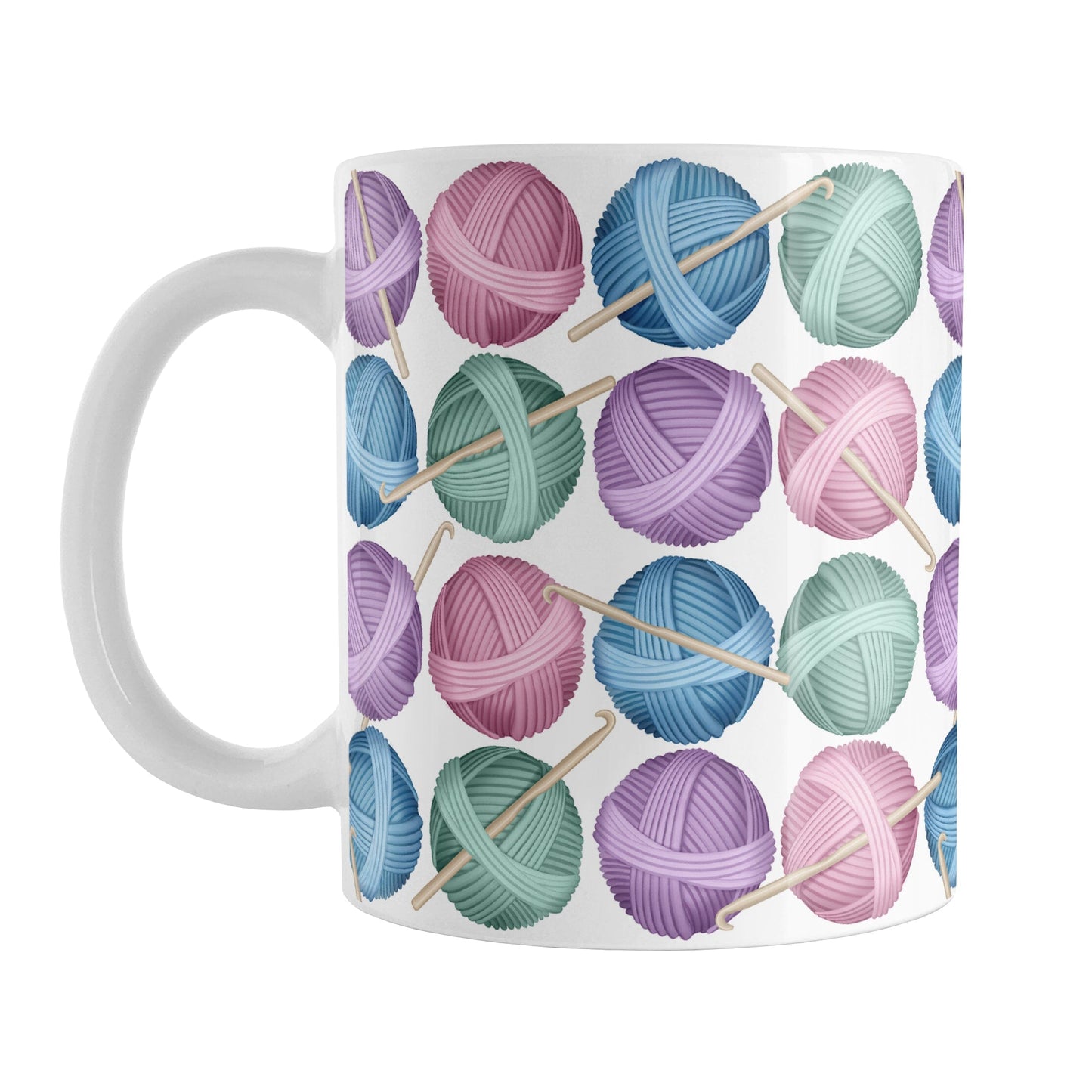 Crochet Yarn Pattern Mug (11oz) at Amy's Coffee Mugs. A ceramic coffee mug designed with colorful balls of yarn in blue, pink, purple, and mint green with crochet hooks in a pattern that wraps around the mug up to the handle. 