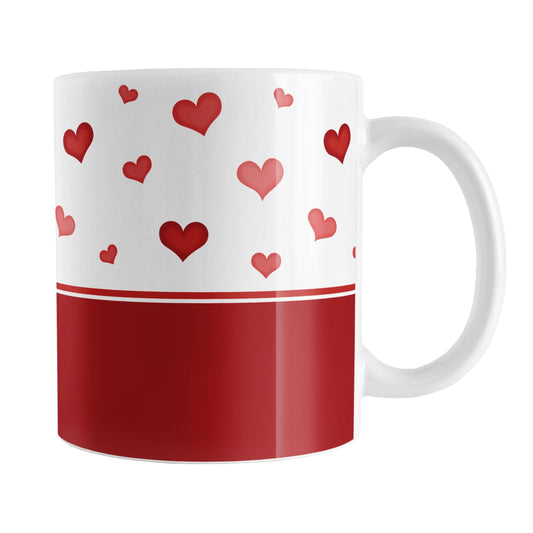 Cute Hearts and Red Mug (11oz) at Amy's Coffee Mugs. A ceramic coffee mug designed with a print of small cute hand-drawn red hearts in different shades of red in a pattern along the top and a tall darker red stripe along the bottom that wraps around the mug to the handle.