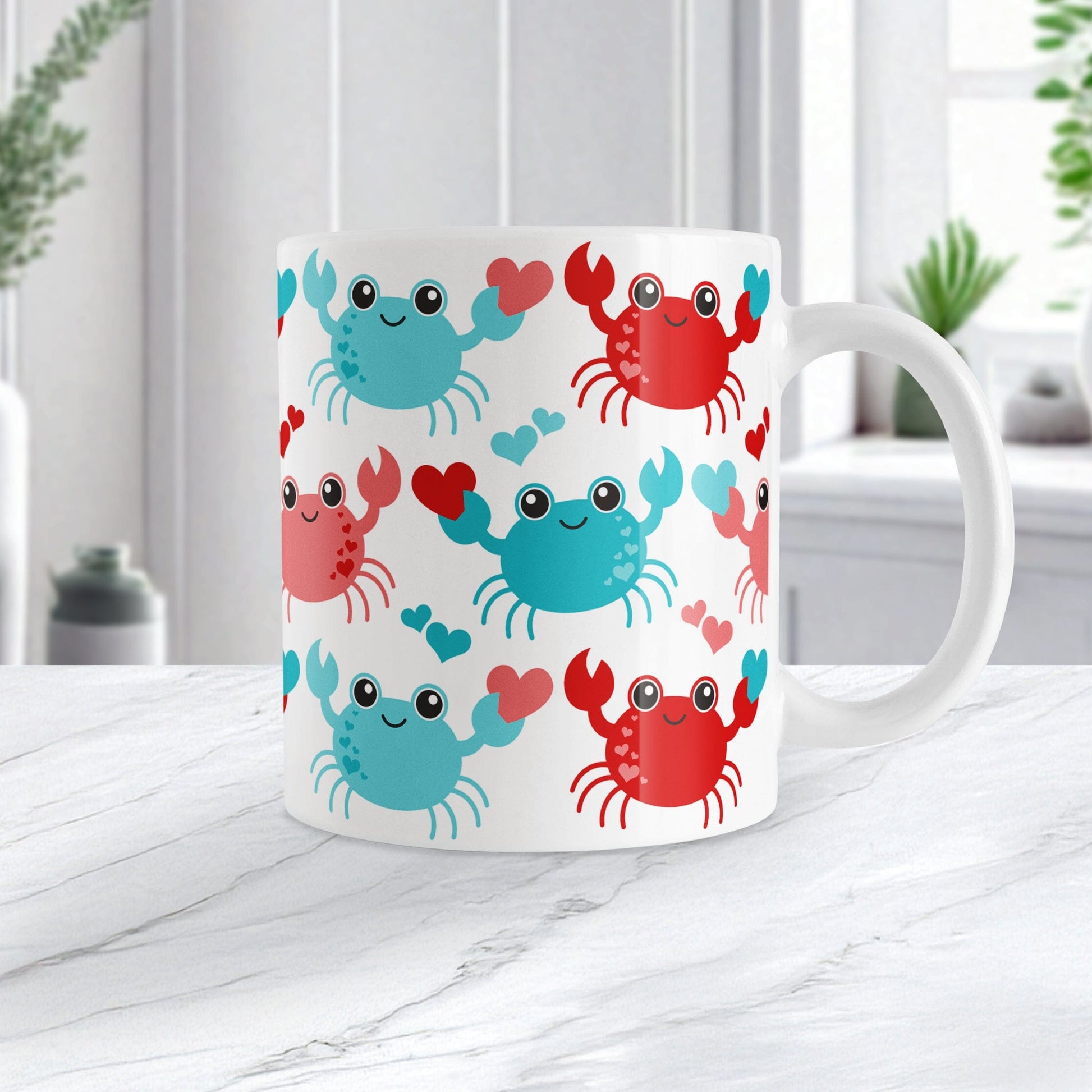11oz white mug with a red and turquoise crabs pattern design, on a marble countertop
