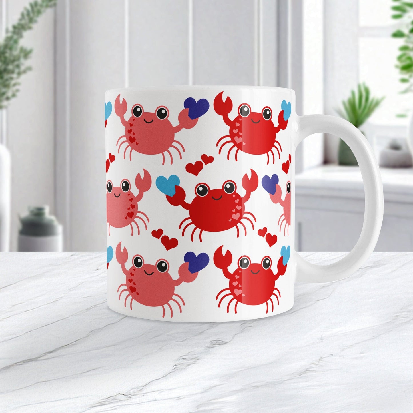 11oz white ceramic coffee mug with an adorable red crabs holding blue hearts design, on a marble countertop