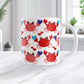 11oz white ceramic coffee mug with an adorable red crabs holding blue hearts design, on a marble countertop