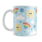 Cute Sunshine and Rainbows Mug (11oz) at Amy's Coffee Mugs. A ceramic coffee mug designed with happy and smiling yellow suns, colorful rainbows, raindrops, and clouds over a blue sky background color in a pattern that wraps around the mug to the handle. 