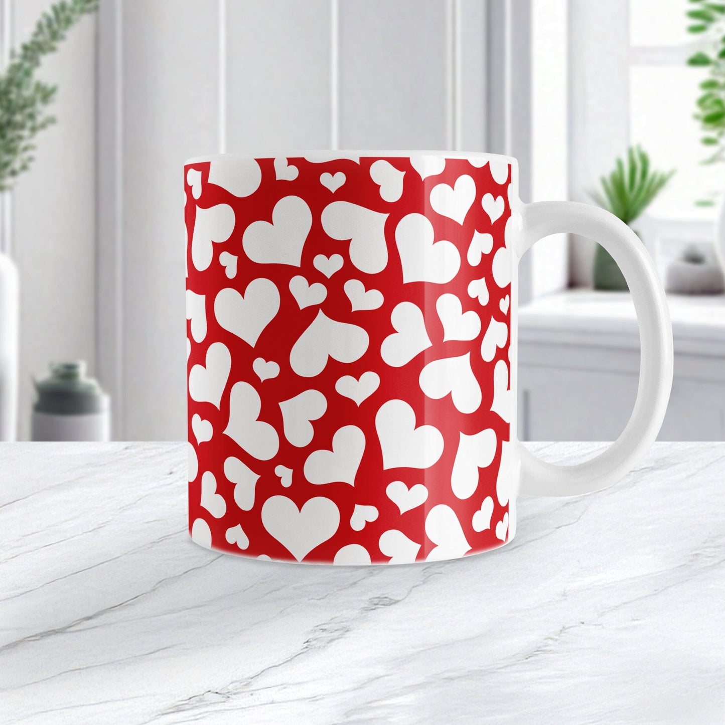 Cute White Hearts on Red Mug (11oz) at Amy's Coffee Mugs. A ceramic coffee mug designed with a multi-directional pattern of cute white hearts over a red background color that wraps around the mug to the handle. Image shows the mug on a white marble countertop.