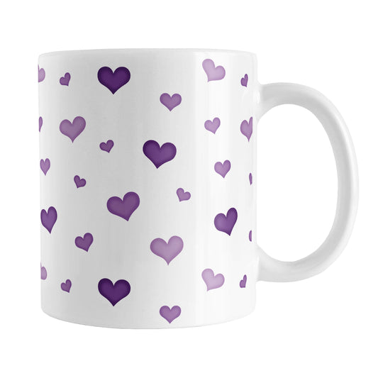 Dainty Cute Purple Hearts Mug (11oz) at Amy's Coffee Mugs. A ceramic coffee mug designed with a print of cute and dainty hand-drawn purple hearts in different shades of purple in a pattern that wraps around the mug up to the handle.