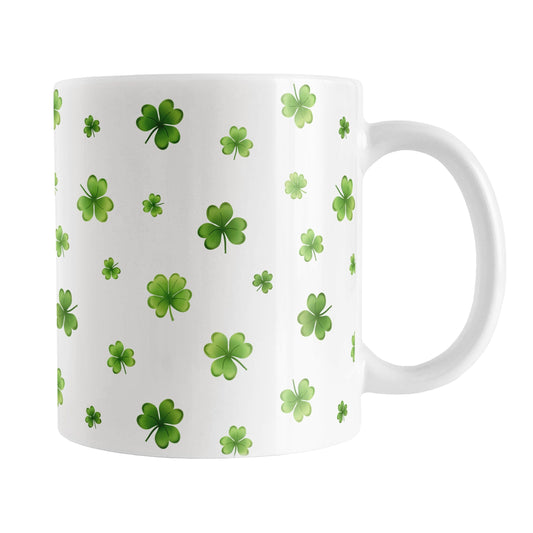 Dainty Shamrocks and Clovers Mug (11oz) at Amy's Coffee Mugs. A ceramic coffee mug designed with hand-drawn green shamrocks and 4-leaf clovers in a dainty minimalist pattern that wraps around the mug up to the handle.