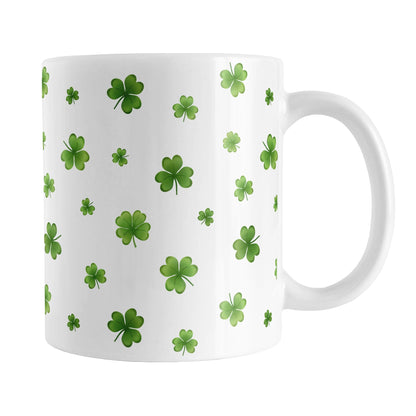 Dainty Shamrocks and Clovers Mug (11oz) at Amy's Coffee Mugs. A ceramic coffee mug designed with hand-drawn green shamrocks and 4-leaf clovers in a dainty minimalist pattern that wraps around the mug up to the handle.