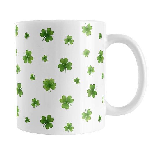 Dainty Shamrocks and Clovers Mug (11oz) at Amy's Coffee Mugs. A ceramic coffee mug designed with hand-drawn green shamrocks and 4-leaf clovers in a dainty minimalist pattern that wraps around the mug up to the handle.