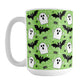Mug with Halloween-themed design featuring ghosts, bats, and spiders on a green background.