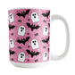 Mug with Halloween-themed design featuring ghosts, bats, and spiders on a pink background.