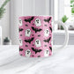 Mug with Halloween-themed design featuring ghosts, bats, and spiders on a pink background.