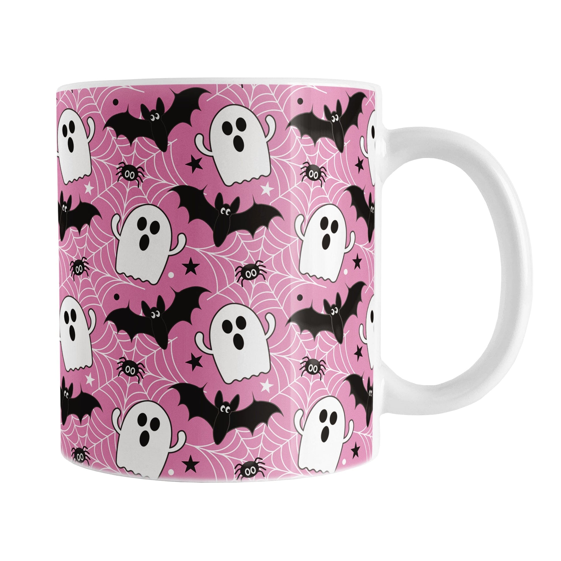 Mug with Halloween-themed design featuring ghosts, bats, and spiders on a pink background.