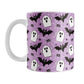 Mug with Halloween-themed design featuring ghosts, bats, and spider webs on a purple background.