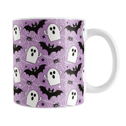 Halloween-themed mug with ghost, bat, and spider pattern on a purple background