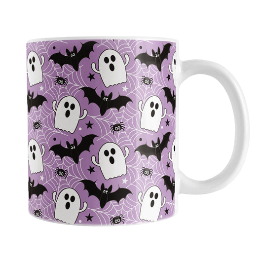 Halloween-themed mug with ghost, bat, and spider pattern on a purple background