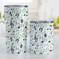 Green Music Notes Pattern Tumbler Cups (20oz or 10oz) at Amy's Coffee Mugs. Stainless steel tumbler cups designed with music notes and symbols in green, black, and gray in a pattern that wraps around the cups. Photo shows both sized cups on a table next to each other. 