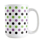 White mug with colorful polka dot pattern in green, purple, and black, on a white background