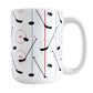 Hockey Rink Pattern Mug (15oz) at Amy's Coffee Mugs. A ceramic coffee mug designed with hockey rink red and blue lines, coupled with hockey sticks and hockey pucks, a pattern that wraps around the mug up to the handle.