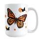 Monarch Butterfly Mug (15oz) at Amy's Coffee Mugs. A ceramic mug designed with an illustration of a monarch butterfly with orange circles and smaller black silhouette butterflies around it. This nature-inspired drawing is on both sides of the mug.