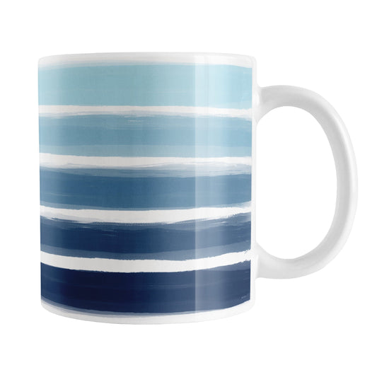Nautical Paint Brush Strokes Mug (11oz) at Amy's Coffee Mugs. A ceramic coffee mug featuring a print of artistic paint brush strokes, in a gradient color progression of navy blue along the bottom to aqua blue along the top, horizontally across the mug up to the handle.