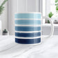 Mug with blue and white stripes on a marble surface