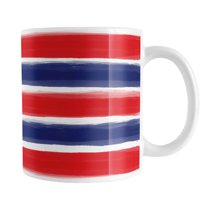 Patriotic Paint Brush Strokes Mug (11oz) at Amy's Coffee Mugs. A ceramic coffee mug featuring a print of artistic paint brush strokes horizontally across the mug up to the handle, in alternating colors of red and blue over white to celebrate the 4th of July (Independence Day) holiday.