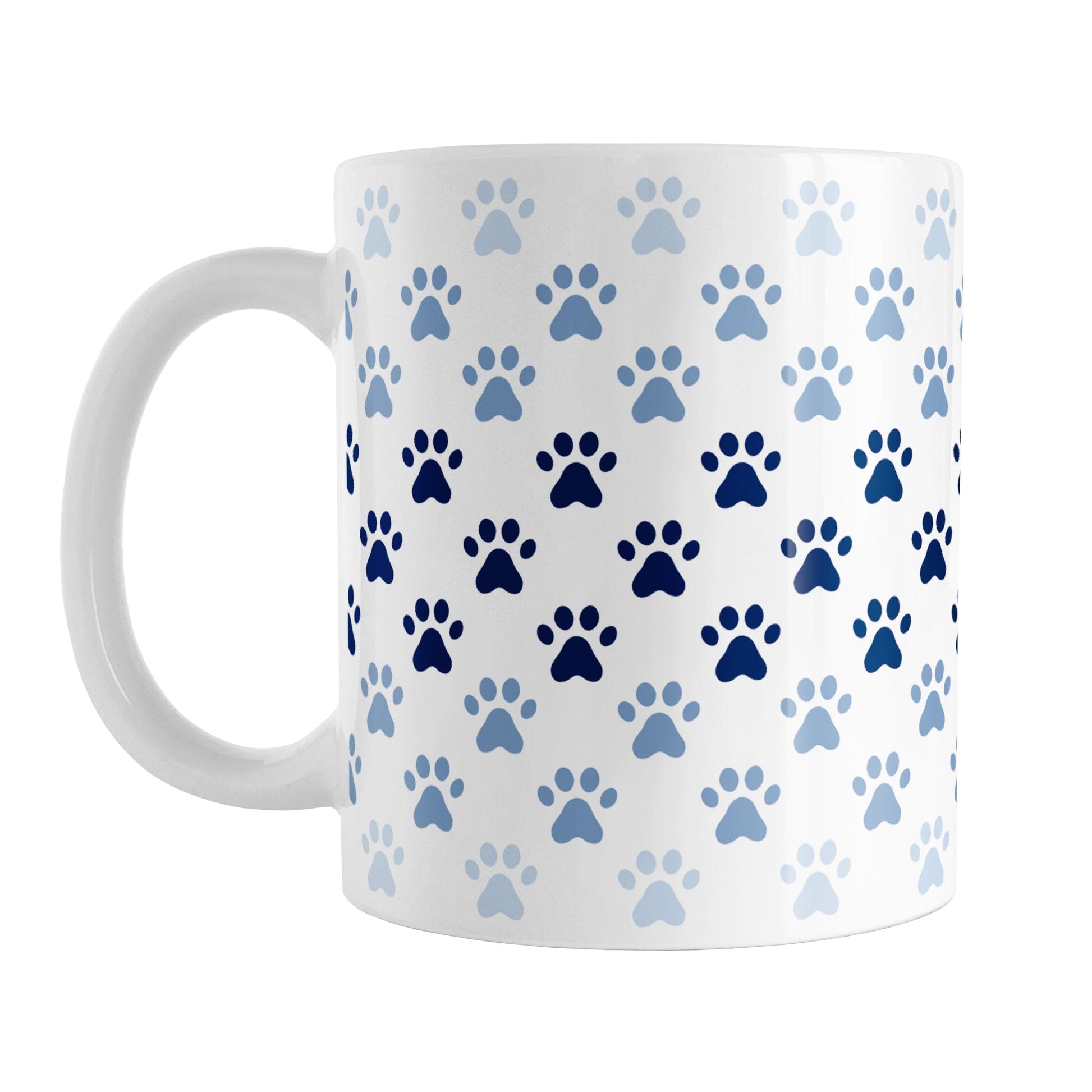 Paw Prints in Blue Mug (11oz) at Amy's Coffee Mugs. A ceramic coffee mug designed with paw prints in different shades of blue, with the darker blue color across the middle and the lighter blue along the top and bottom, in a pattern that wraps around the mug to the handle.