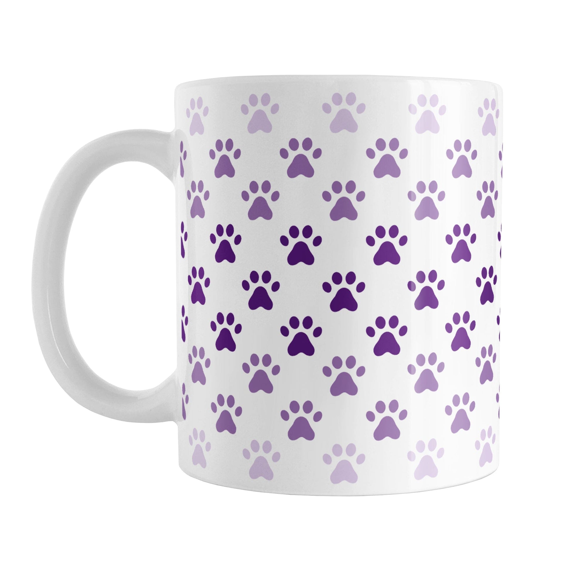 Paw Prints in Purple Mug (11oz) at Amy's Coffee Mugs. A ceramic coffee mug designed with paw prints in different shades of purple, with the darker purple color across the middle and the lighter purple along the top and bottom, in a pattern that wraps around the mug to the handle.