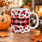 11 oz personalized fall mug with red and black buffalo plaid, assorted autumn leaf shapes, custom white script name, and wide checkered center band.