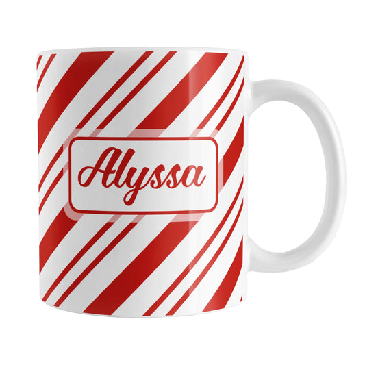 Personalized Candy Cane Stripe Mug (11oz) at Amy's Coffee Mugs. A ceramic coffee mug with your name personalized on both sides of the mug over a candy cane stripe pattern that wraps around the mug up to the handle.