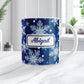 Personalized Classic Blue Snowflake Winter Mug (11oz) at Amy's Coffee Mugs. A ceramic coffee mug designed with a pattern of different shades of blue snowflakes over a classic blue background color that wraps around the mug to the handle. Your name is custom printed in a blue script font on both sides of the mug. Image shows the mug on a white marble countertop.