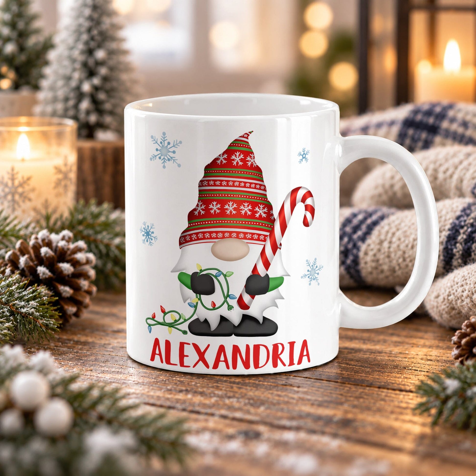 11 oz personalized Christmas gnome mug with red and green snowflake hat, large candy cane, colorful lights, blue snowflakes, and custom name below, displayed on a wooden table with cozy winter decor around it.