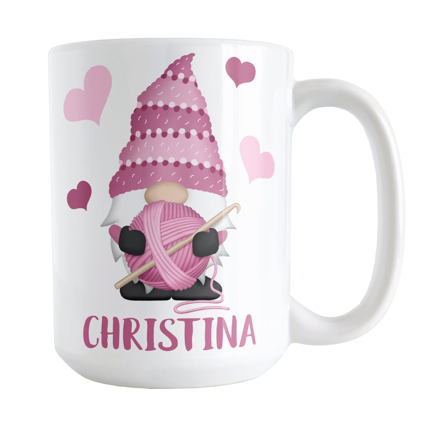 Personalized Pink Crochet Gnome Mug (15oz) at Amy's Coffee Mugs. A ceramic coffee mug designed with a cute gnome wearing a pink crochet hat while holding a ball of pink yarn and a crochet hook with pink hearts around him. Your name is printed in a fun pink font below the gnome. This adorable illustration and personalization is on both sides of the mug. 