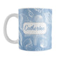 Personalized White Seashell Pattern Blue Beach Mug (11oz) at Amy's Coffee Mugs. A ceramic coffee mug designed with a white seashell line drawing pattern over a blue background that wraps around the mug up to the handle. Your name is personalized on this beach mug over the blue seashell pattern.