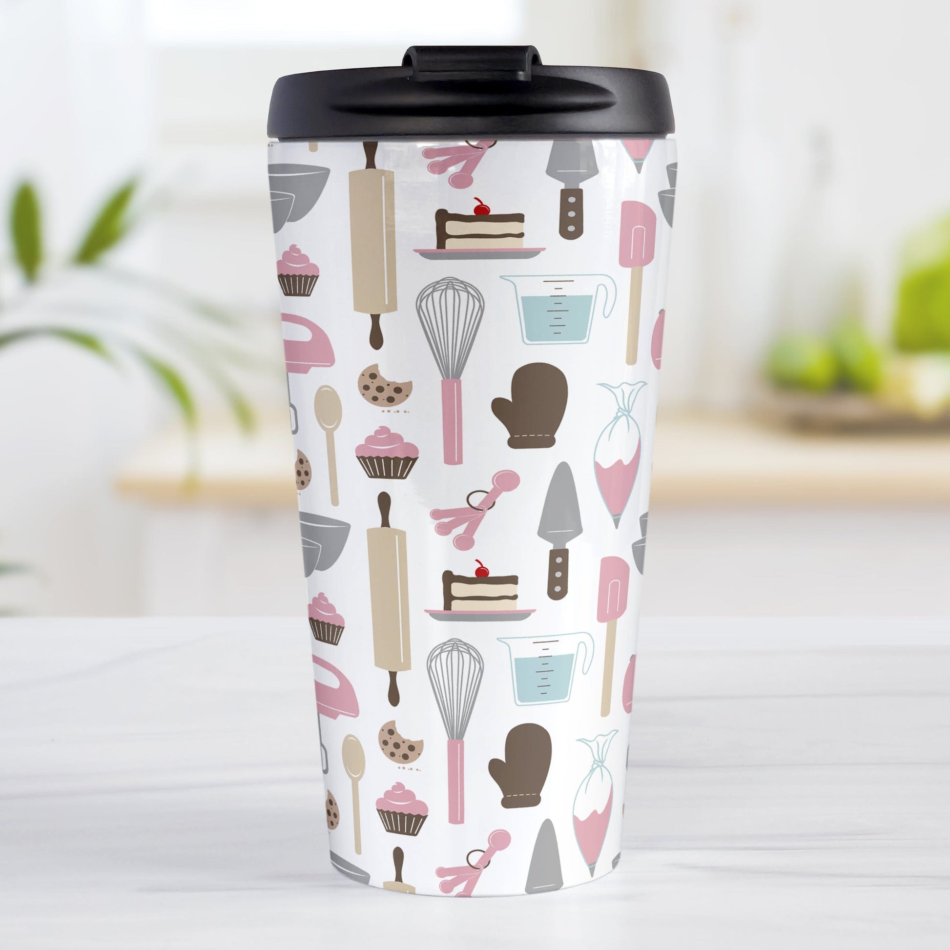 Pink Baking Pattern Travel Mug (15oz) at Amy's Coffee Mugs. A stainless steel travel mug designed with a pattern of baking tools like spatulas, whisks, mixers, bowls, and spoons, with cookies, cupcakes, and cake all in a pink, gray, brown, and beige color scheme that wraps around the travel mug. 