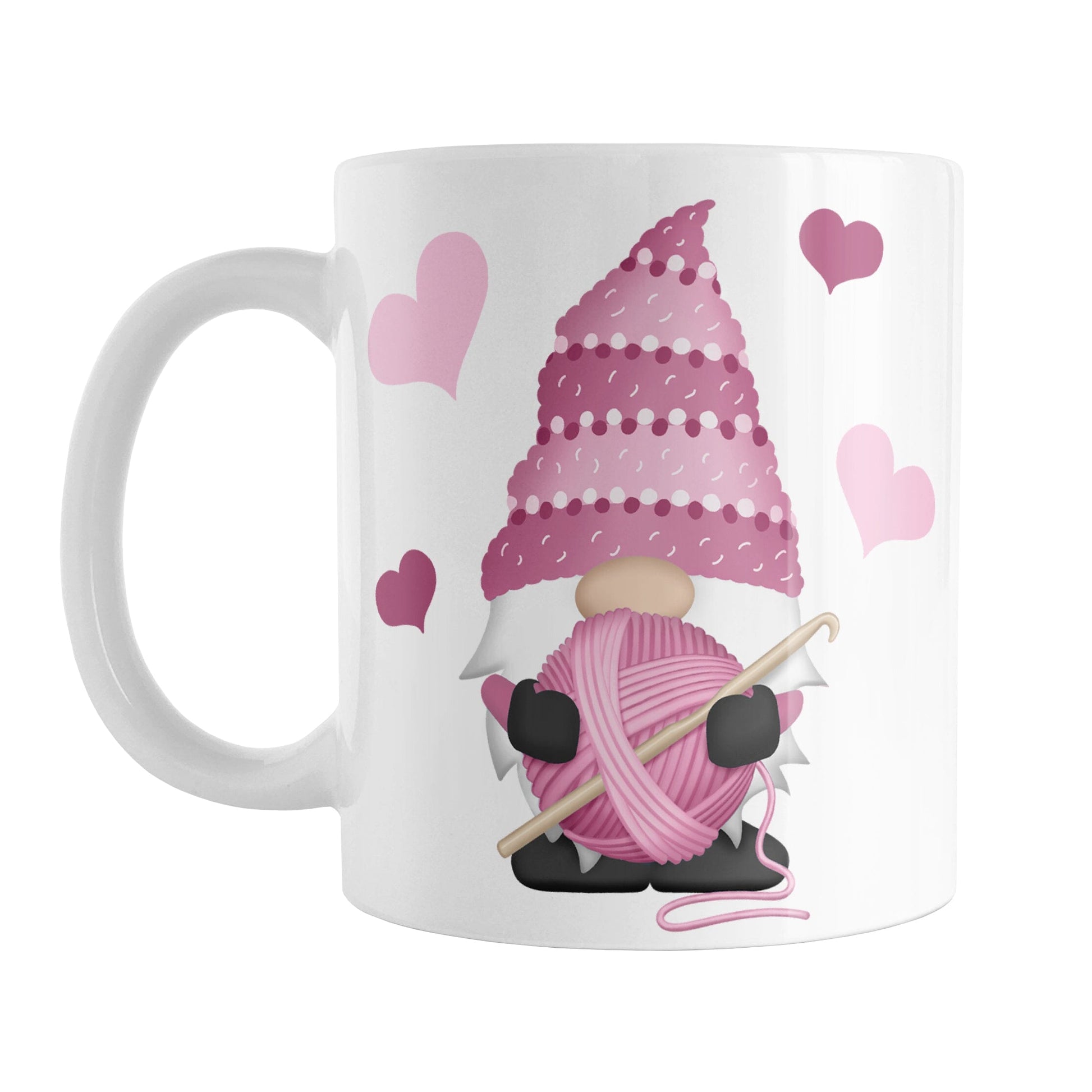 Pink Crochet Gnome Mug (11oz) at Amy's Coffee Mugs. A ceramic coffee mug designed with a cute gnome wearing a pink crochet hat while holding a ball of pink yarn and a crochet hook with pink hearts around him. This adorable crochet gnome illustration is on both sides of the mug. 