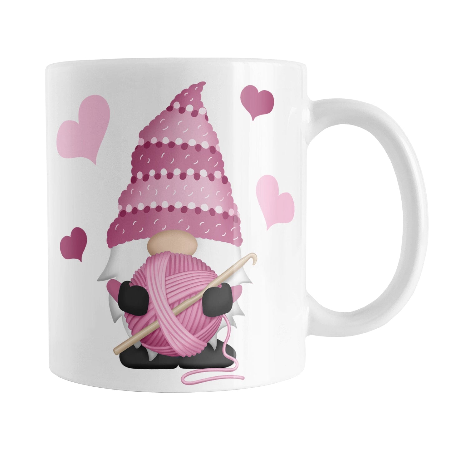 Pink Crochet Gnome Mug (11oz) at Amy's Coffee Mugs. A ceramic coffee mug designed with a cute gnome wearing a pink crochet hat while holding a ball of pink yarn and a crochet hook with pink hearts around him. This adorable crochet gnome illustration is on both sides of the mug. 